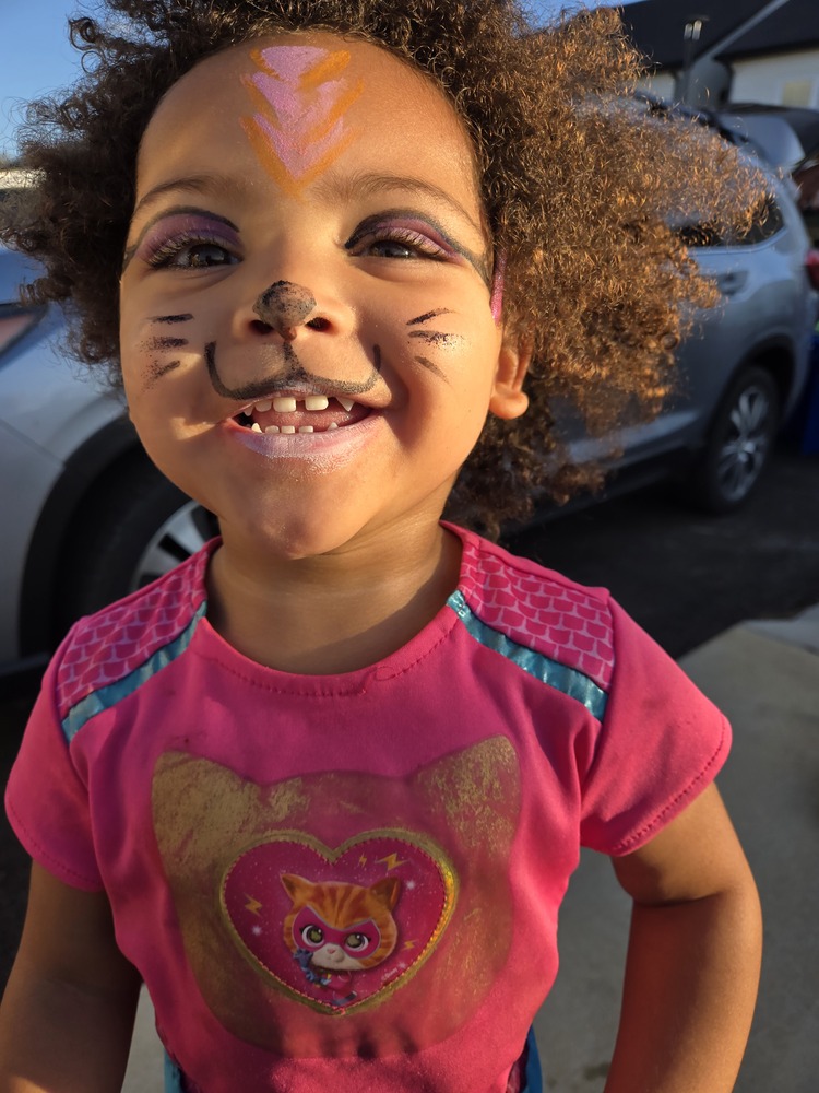 Resident child with kitten face paint